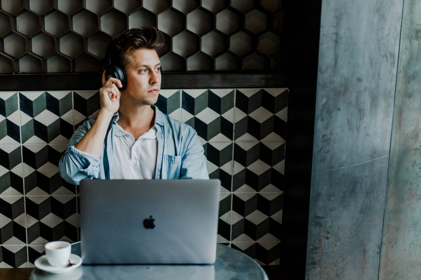 guy at cafe on laptop and headphones-austin-distel